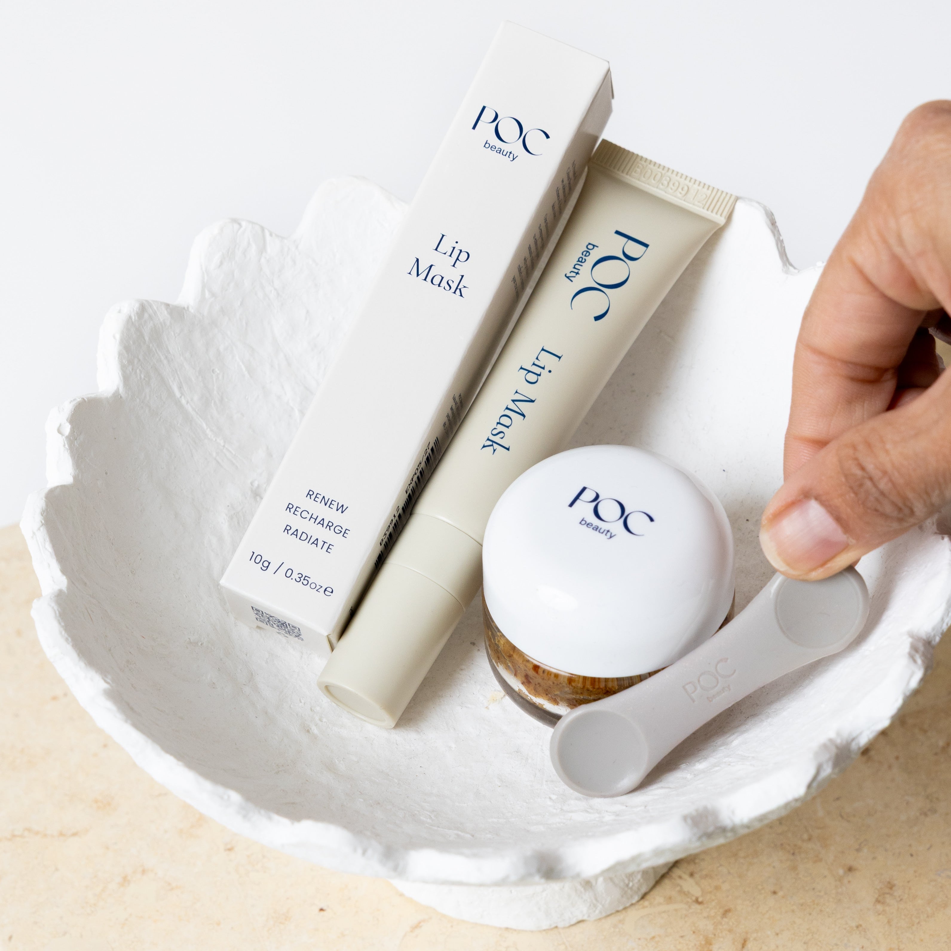POC beauty lip duo bundle in a white ceramic scalloped bowl.